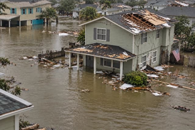 Flood and storm damaged home surrounded by water Flood and storm damaged home surrounded by water